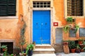 Classic italian house with blue door and orange walls Royalty Free Stock Photo