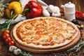 Classic Italian pizza margarita on a wooden plate Royalty Free Stock Photo