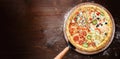 Classic Italian pizza on a wooden tray, served in a small authentic Italian restaurant Royalty Free Stock Photo