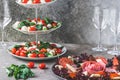 Classic Italian salad Insalata Caprese and a plate with a selection of sausage specialties