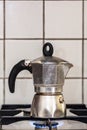 Classic Italian style moka coffee pot on the gas stove with fire