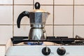 Classic Italian style moka coffee pot on the gas stove with fire Royalty Free Stock Photo