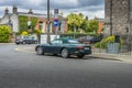 Classic Jaguar parked in south Dublin, Ireland against a house