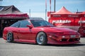 Classic Japanese red Nissan Silvia S13 sports car parked on the street