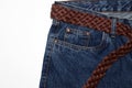 Classic jeans with five pockets close-up. jeans with a woven belt of brown leather and coarse thick threads. vintage blue textured Royalty Free Stock Photo