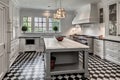 classic kitchen with sleek appliances, marble countertops, and vintage tile flooring