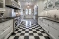 classic kitchen with sleek appliances, marble countertops, and vintage tile flooring