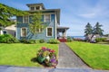 Classic large craftsman old American house exterior in blue tones with well kept garden Royalty Free Stock Photo