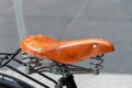 Classic leather bike saddle with metal spring. Brown bicycle seat Royalty Free Stock Photo