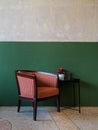 Classic lined pattern armchair with green vintage cafe wall Royalty Free Stock Photo