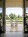 Classic luxury chairs on large balcony with garden view. Copy space provided.