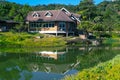 Classic luxury house with water reflection, green garden and canal in Pilok old mining in E-Thong village, Pilok,Thong Pha Phum Royalty Free Stock Photo