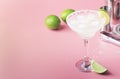 Classic margarita alcohol cocktail with tequila, liqueur, lime juice, sugar syrup, salt and ice, summer pink background, place for Royalty Free Stock Photo