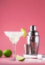 Classic margarita alcohol cocktail with tequila, liqueur, lime juice, sugar syrup, salt and ice, summer pink background, place for Royalty Free Stock Photo