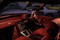 Classic Mazda car interior with red velours and leather and sports Mazda RX-7 in the retro garage