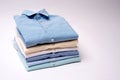 Classic men`s shirts stacked on white background. Royalty Free Stock Photo