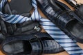 Classic men`s shoes, tie, cufflinks, gloves, belt, purse on the wooden floor, can be used as background Royalty Free Stock Photo