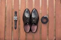 Classic men shoes, belt and watch on wooden boards. Royalty Free Stock Photo