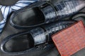 Classic mens blue shoes, tie, umbrella, purse on natural leather