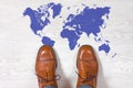 Classic mens shoes with a world map outline on the floor