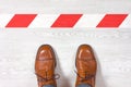 Classic mens shoes in front of a keep out red and white line