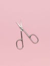 Classic metal nail scissors on a pink background Royalty Free Stock Photo