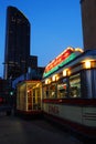 The classic diner contrasts against the modern buildings