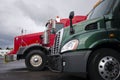 Classic and modern red and green semi trucks