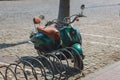 A classic motor scooter stands in the parking lot. A small two-wheeled vehicle for moving around the city