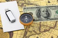 Classic navigation compass on American dollars flash drive on white paper on old vintage world map as symbol of tourism with compa Royalty Free Stock Photo