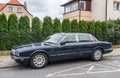 Classic old dark blue Jaguar sedan left side view