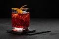 Classic Negroni Cocktail in a retro glass with ice and orange peel on a black background Royalty Free Stock Photo