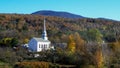 Classic new england white church at stowe and hill with fall foliage Royalty Free Stock Photo