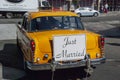 Classic New York Yellow cab vintage car carrying a Just married sign