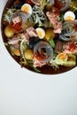 Classic nicoise in the author's serving tuna salad with fresh vegetables on a white napkin, canned tuna with masilnas Royalty Free Stock Photo