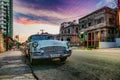 Classic Old American Car in the streets of the Old Havana City. Sunset Sky Royalty Free Stock Photo