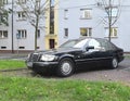 Classic old black sedan car Mercedes Benz S320 front and left side view parked