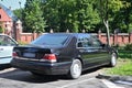 Classic old black sedan car Mercedes Benz S320 rear and right side view parked