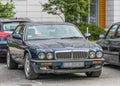 Classic old dark blue Jaguar sedan front side view