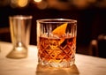 Classic old fashioned cocktail with orange peel on bar counter.Macro.AI Generative