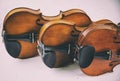 The classic old film design background of wooden violin,three violins stacked on board,warm light tone,grainy film design Royalty Free Stock Photo