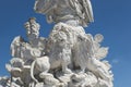 classic old Greek style white stone sculpture detail of warrior with lions at his feet at the Schonbrunn palace
