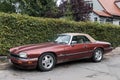 Classic old purple red Jaguar convertible left side view