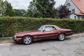 Classic old purple red Jaguar convertible left side view