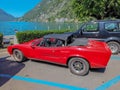 Classic old red car parked on the shore of Lake Lugano in Italy Royalty Free Stock Photo