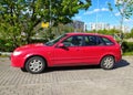 Classic old red Mazda 323 E hatchback private car parked