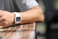 Classic old retro electronic wrist watch on a male hand at a table