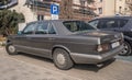 Classic old sedan car Mercedes Benz 560 SEL rear and left side view parked