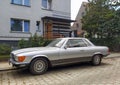 Classic old silver grey coupe car Mercedes Benz 500 SLC 5.0 litre front and left side view parked Royalty Free Stock Photo