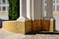 classic old white stucco covered stone columns on yellow stone base. worn and weathered hardwood floor. Royalty Free Stock Photo